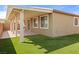 Backyard view showing the covered patio, low-maintenance turf, and neutral-toned home exterior at 2091 Hunt Woods Ct, Laughlin, NV 89029