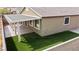 This backyard has a covered patio, artificial turf, and a low brick wall at 2091 Hunt Woods Ct, Laughlin, NV 89029