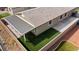 This backyard has a covered patio, artificial turf, and a low brick wall at 2091 Hunt Woods Ct, Laughlin, NV 89029