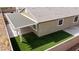 This backyard has a covered patio, artificial turf, and a low brick wall at 2091 Hunt Woods Ct, Laughlin, NV 89029