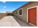 Backyard view featuring a turf lawn, concrete patio, and doorway with outdoor access at 2091 Hunt Woods Ct, Laughlin, NV 89029