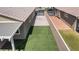 Aerial view of backyard with turf lawn, hardscape, patio cover, and home design at 2091 Hunt Woods Ct, Laughlin, NV 89029