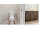 Bathroom features tiled floors, toilet and wooden vanity with granite countertop at 2091 Hunt Woods Ct, Laughlin, NV 89029