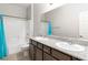 Bathroom featuring a double sink vanity, granite countertop, and shower-tub combo at 2091 Hunt Woods Ct, Laughlin, NV 89029