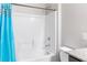 Bathroom featuring a white shower-tub combo with a bright turquoise shower curtain at 2091 Hunt Woods Ct, Laughlin, NV 89029