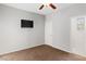 This bedroom has neutral carpet, a TV and a door to an ensuite at 2091 Hunt Woods Ct, Laughlin, NV 89029
