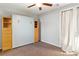 Neutral bedroom with a Murphy bed and a full length curtain over a glass panel door at 2091 Hunt Woods Ct, Laughlin, NV 89029