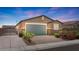 Charming single-story home featuring desert landscaping, a two-car garage, and a secure gated entrance at 2091 Hunt Woods Ct, Laughlin, NV 89029