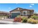 Charming single-story home featuring a well-maintained front yard and a two-car garage at 2091 Hunt Woods Ct, Laughlin, NV 89029