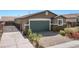 Well-maintained single-story home with a lush front yard, a two-car garage, and a gated side entrance at 2091 Hunt Woods Ct, Laughlin, NV 89029
