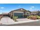 Charming single-story home with a two-car garage, brick accents, and desert landscaping at 2091 Hunt Woods Ct, Laughlin, NV 89029