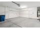 This is a two car garage with concrete floors, shelving, and a white door at 2091 Hunt Woods Ct, Laughlin, NV 89029