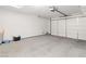 This is a two car garage with concrete floors and a white door at 2091 Hunt Woods Ct, Laughlin, NV 89029