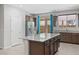 Spacious kitchen featuring a granite-topped island, stainless steel appliances, and dark wood cabinetry at 2091 Hunt Woods Ct, Laughlin, NV 89029