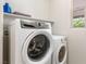 Laundry room featuring front load washer and dryer with a window at 2091 Hunt Woods Ct, Laughlin, NV 89029