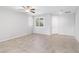 Spacious living room featuring neutral paint, tile flooring, and a ceiling fan for comfortable living at 2091 Hunt Woods Ct, Laughlin, NV 89029