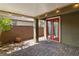 Relax on this covered brick patio with a red framed glass panel door at 2091 Hunt Woods Ct, Laughlin, NV 89029