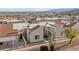 Aerial view of the community featuring townhomes with red tile roofs, desert landscaping and mountain views at 2146 High Dunes Ln, Laughlin, NV 89029