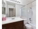 Bathroom featuring dark cabinets, tile backsplash, and a shower-tub combination at 2146 High Dunes Ln, Laughlin, NV 89029