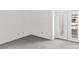 A modern bedroom with gray carpet, white walls, and a glass door at 2146 High Dunes Ln, Laughlin, NV 89029