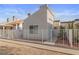 Charming home featuring neutral stucco, white fence, desert landscaping, address numbers, and blue sky at 2146 High Dunes Ln, Laughlin, NV 89029