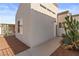 Townhouse exterior featuring neutral stucco, desert landscaping, and bright blue sky at 2146 High Dunes Ln, Laughlin, NV 89029
