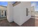 Townhouse exterior featuring neutral stucco, desert landscaping, and bright blue sky at 2146 High Dunes Ln, Laughlin, NV 89029