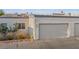 Exterior view of Las Vegas townhouse with attached garage and desert landscaping at 2146 High Dunes Ln, Laughlin, NV 89029