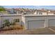 Elevated exterior view of Las Vegas townhouse with attached garage and desert landscaping at 2146 High Dunes Ln, Laughlin, NV 89029
