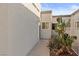 Townhouse exterior featuring neutral stucco, desert landscaping, and bright blue sky at 2146 High Dunes Ln, Laughlin, NV 89029