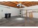 Garage with concrete flooring, overhead wood beams, shelving, and a hot water heater at 2146 High Dunes Ln, Laughlin, NV 89029