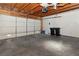 Bright garage featuring concrete flooring, wooden beam ceiling, and a white garage door at 2146 High Dunes Ln, Laughlin, NV 89029