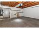 Spacious garage with concrete floor, shelving, ceiling fan, and hot water tank at 2146 High Dunes Ln, Laughlin, NV 89029