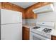 A kitchen with wood cabinets, white appliances, and light countertops at 2146 High Dunes Ln, Laughlin, NV 89029