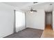 Neutral living room with carpet and tile floors, featuring a ceiling fan and window at 2146 High Dunes Ln, Laughlin, NV 89029