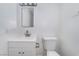 Modern bathroom featuring a vanity, sink, toilet, and a mirror, providing essential amenities at 2716 Saber Dr, North Las Vegas, NV 89032