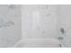 Close up of the bathtub with marble look tile surround at 2716 Saber Dr, North Las Vegas, NV 89032