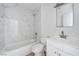 Bathroom features marble look tile surround, a modern sink and vanity, and a toilet at 2716 Saber Dr, North Las Vegas, NV 89032