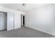 Bedroom features neutral carpet and a door to connecting room and closet with shelving at 2716 Saber Dr, North Las Vegas, NV 89032