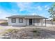 Curb view of a charming single-story home with desert landscaping at 2716 Saber Dr, North Las Vegas, NV 89032
