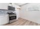 New kitchen with stainless steel oven, white cabinets and new flooring at 2716 Saber Dr, North Las Vegas, NV 89032