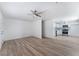 Open-concept living room with light wood floors that connect to the updated kitchen at 2716 Saber Dr, North Las Vegas, NV 89032