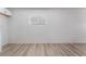Bright, open living room featuring modern wood floors and a sunlit window at 2716 Saber Dr, North Las Vegas, NV 89032