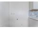 Utility room with modern cabinets and countertop with tile backsplash at 2716 Saber Dr, North Las Vegas, NV 89032