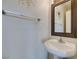 Contemporary half bath with a pedestal sink, modern fixtures, and decorative mirror at 2787 Fountain Ridge Ln, Henderson, NV 89074