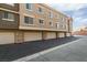 Building exterior features garages, windows, and a paved driveway for parking convenience at 2787 Fountain Ridge Ln, Henderson, NV 89074