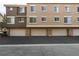 Building exterior showcases multiple garages and windows along a paved parking area at 2787 Fountain Ridge Ln, Henderson, NV 89074