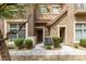 Close-up of townhouse exterior featuring a stone accent, walkway, and efficient air conditioning at 2787 Fountain Ridge Ln, Henderson, NV 89074