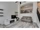 Open-concept living room with high ceilings, featuring floating shelves and stylish furniture at 2787 Fountain Ridge Ln, Henderson, NV 89074