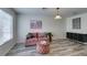 Charming living room features a comfortable pink sofa and stylish decor at 2787 Fountain Ridge Ln, Henderson, NV 89074
